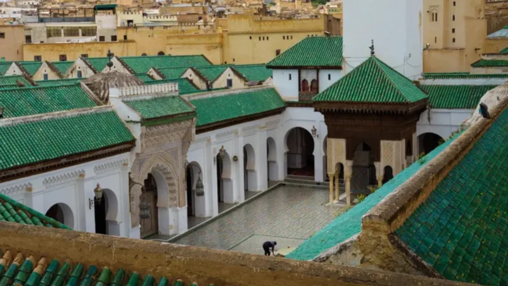 The courtyard of Al-Qarawiyyin Mosque in Fez, Morocco, featuring green-tiled roofs and white arches a must-visit destination on any one week Morocco itinerary with a local guide