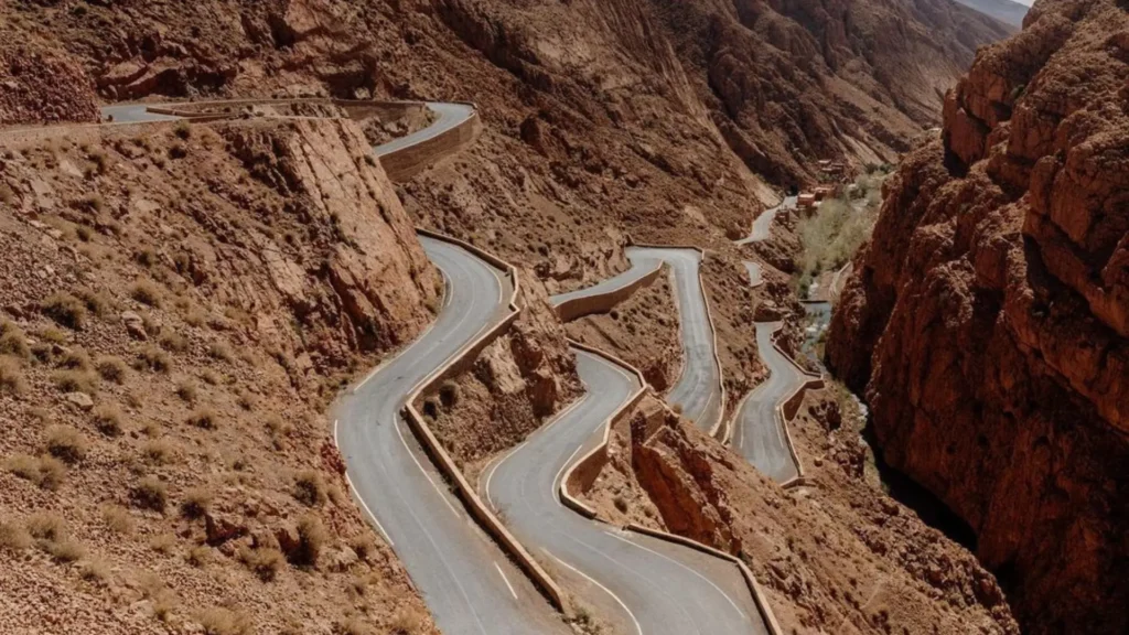 A winding mountain road with sharp curves in the Aït Sedrat area near Boumalne Dades, set amid dry rocky terrain during a one week trip in Morocco