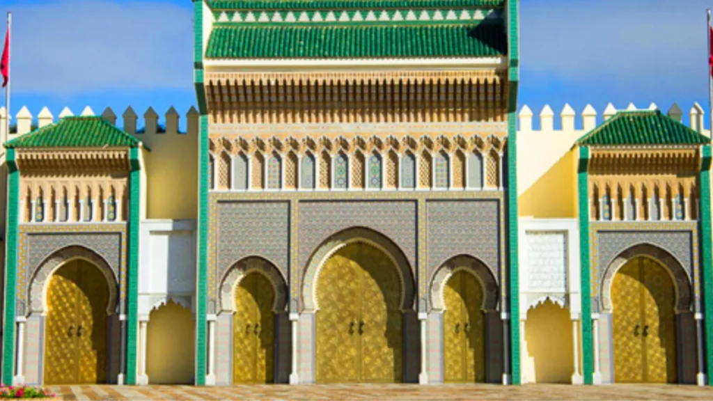 Facade of a royal palace in Fes with golden arches and intricate Islamic architectural decorations