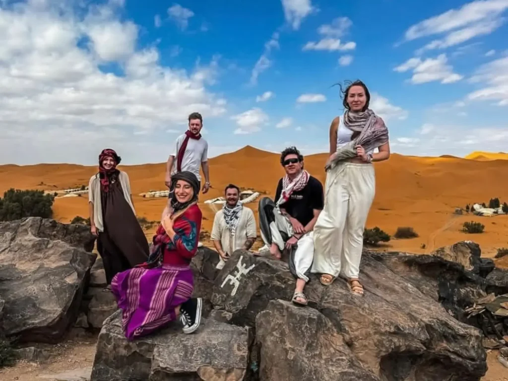 A tourist overlooking the High Atlas mountains and the distant Sahara desert during a 4-day tour from Fes to Marrakech.