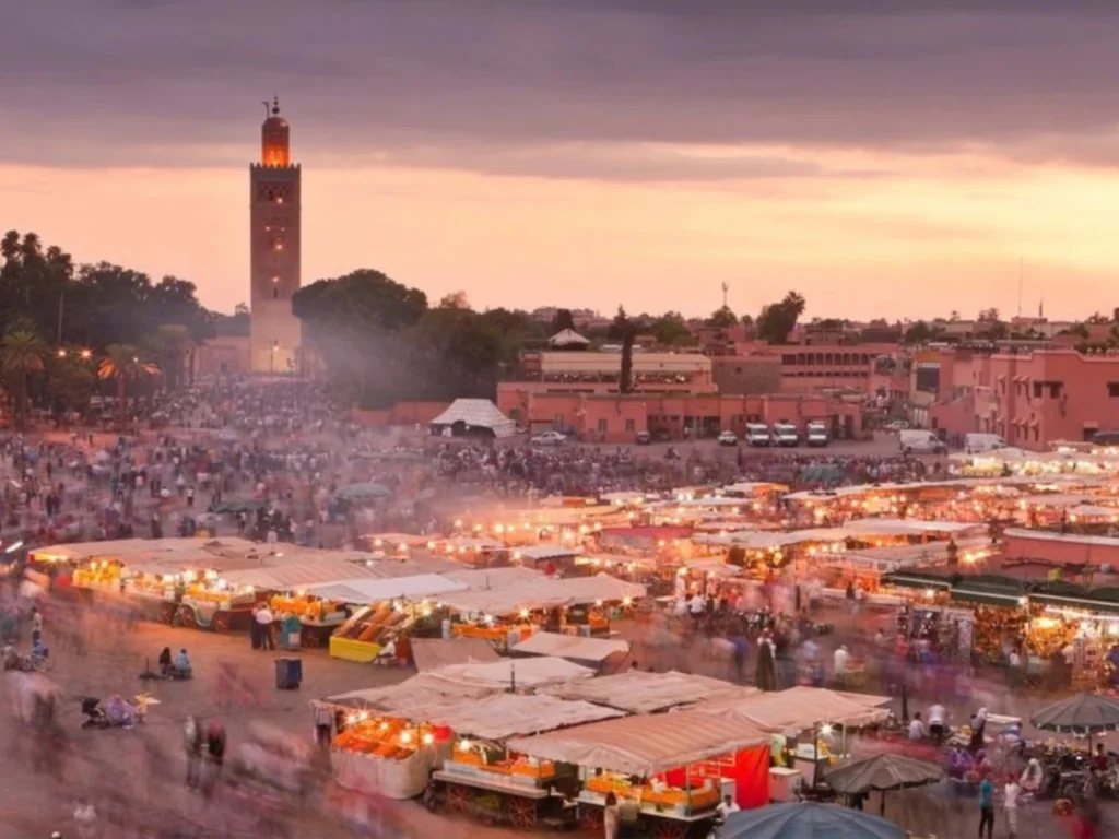 Golden sunset over Jemaa el-Fnaa square in Marrakech, the final stop when you travel from Fes to Marrakech.